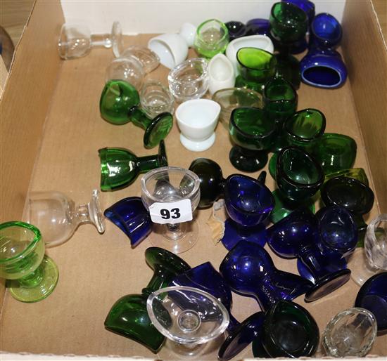 A collection of green and clear glass eye baths